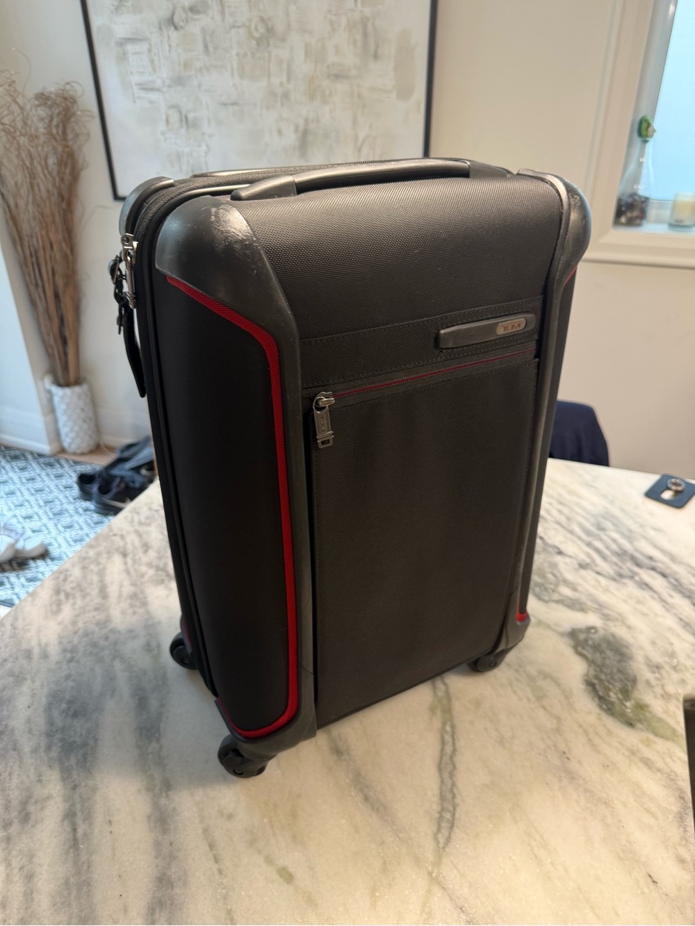 Tumi Black Carry-On Spinner with Red Accents